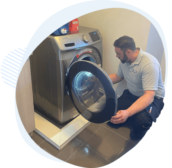 appliance repair technician fixing washer