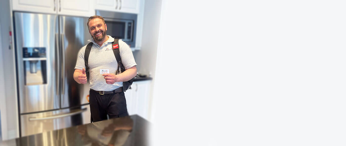 appliance repair technician finished fixing a fridge