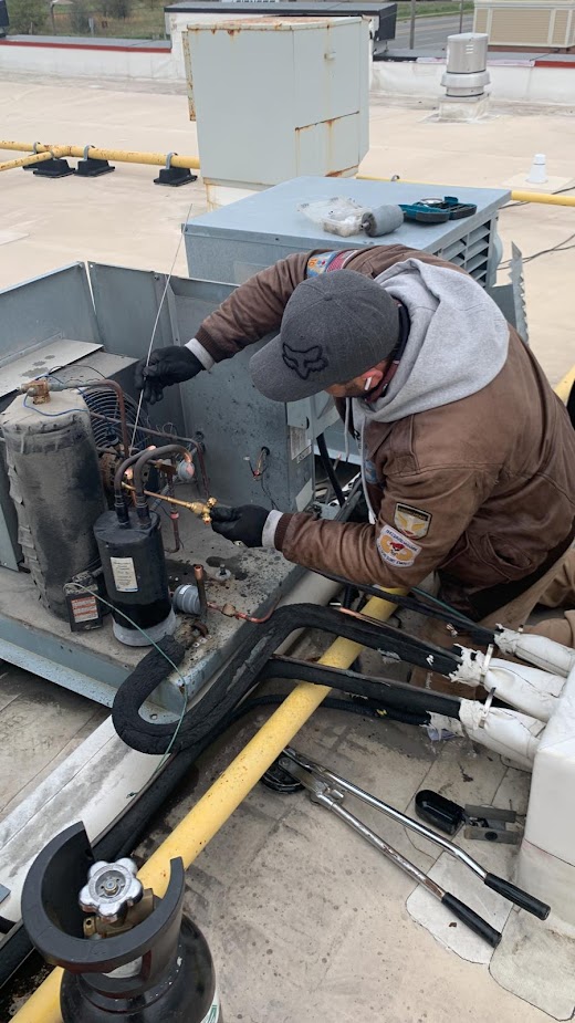 CooperFix technician replacing a rooftop refrigeration compressor in Toronto