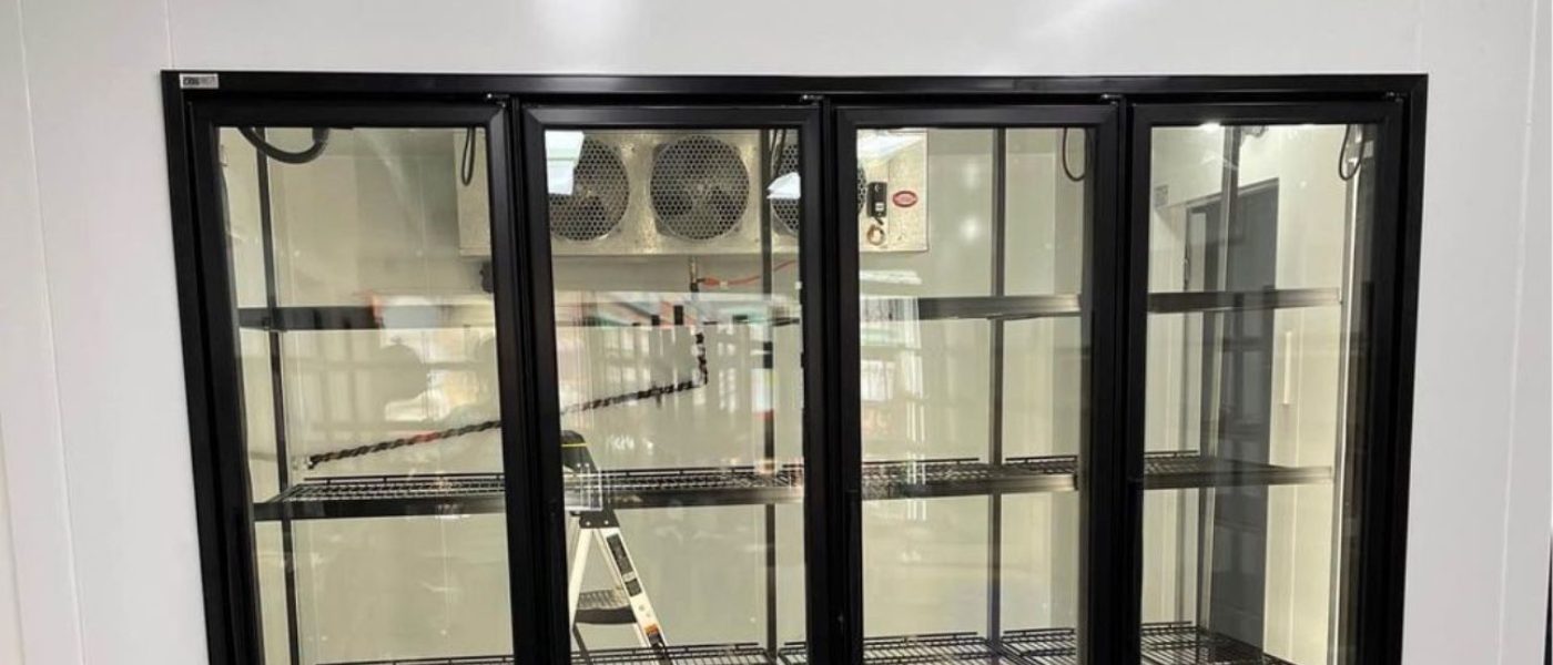 Commercial glass-door display refrigerator in a retail space
