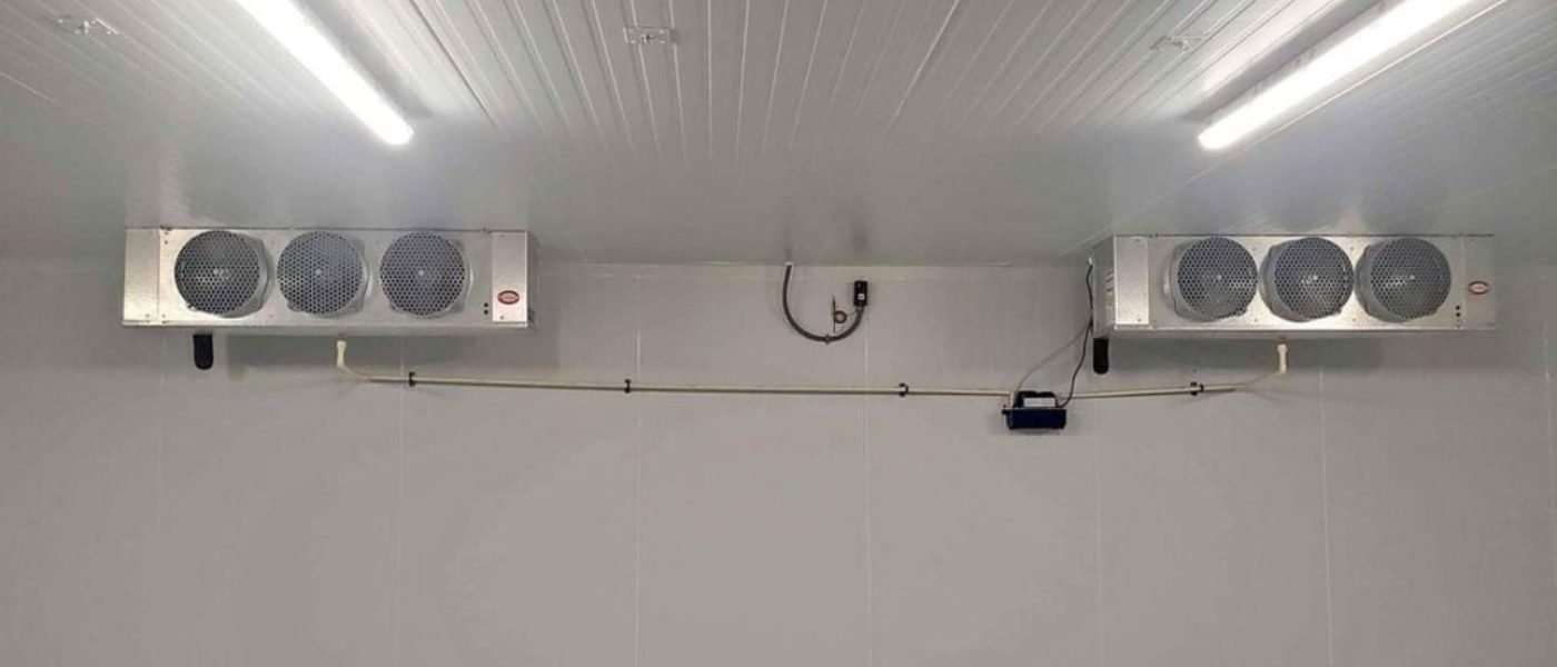 Interior of a commercial walk-in cooler with ceiling evaporator units