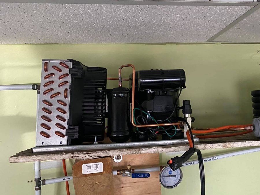 CooperFix condensing unit with service gauges connected during a commercial refrigeration repair
