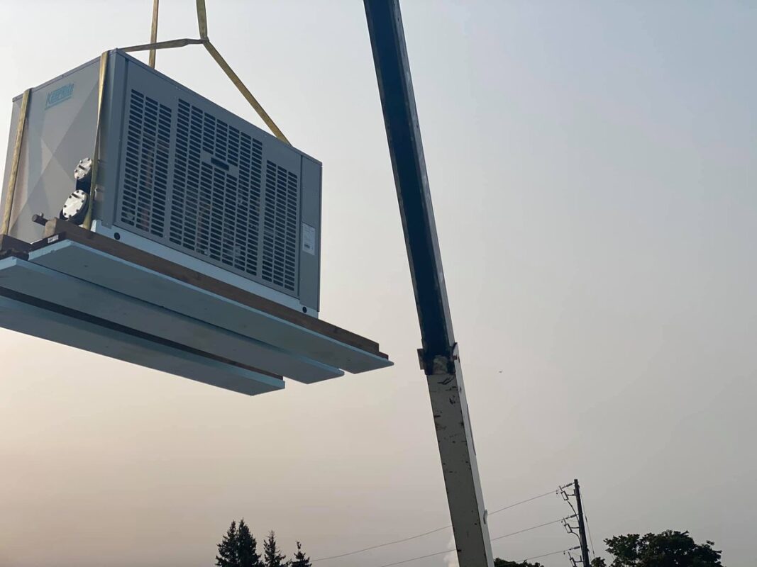 Refrigeration unit lifted to the roof by crane