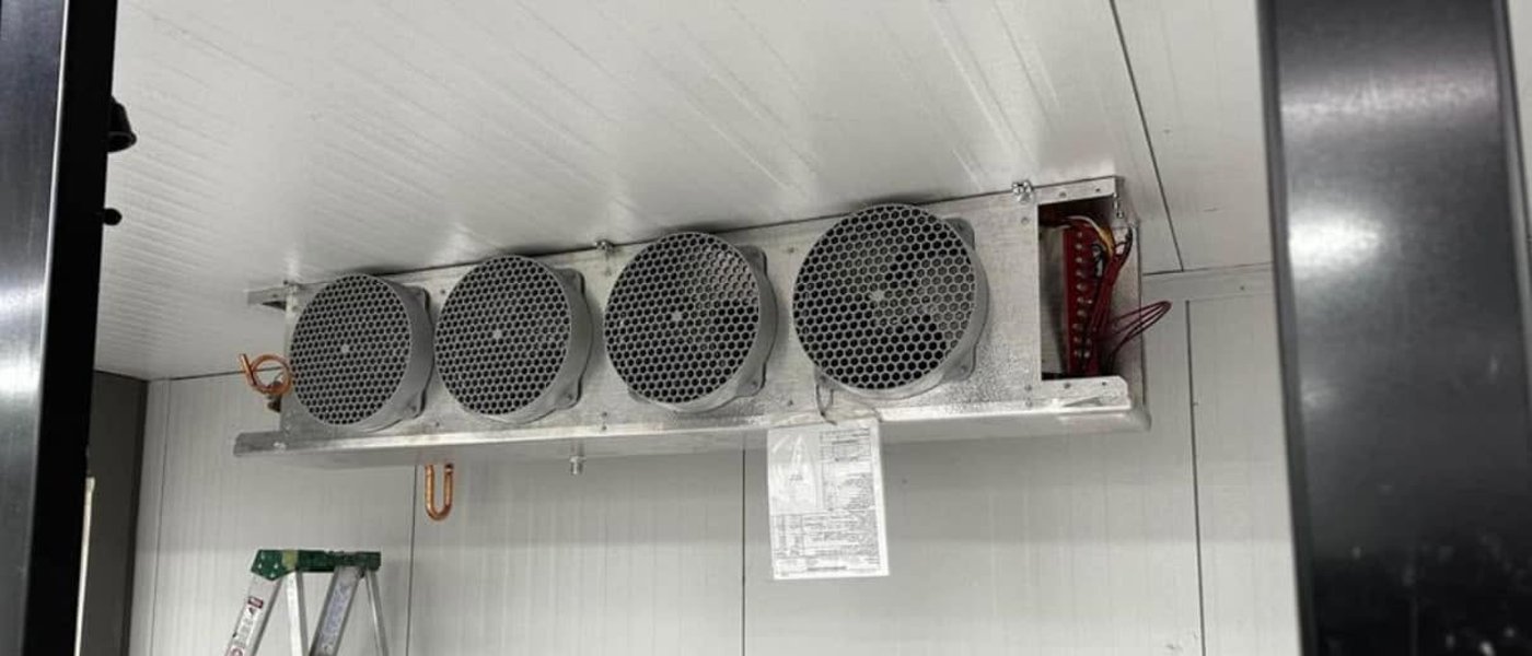 Four-fan evaporator in a commercial walk-in freezer serviced by CooperFix