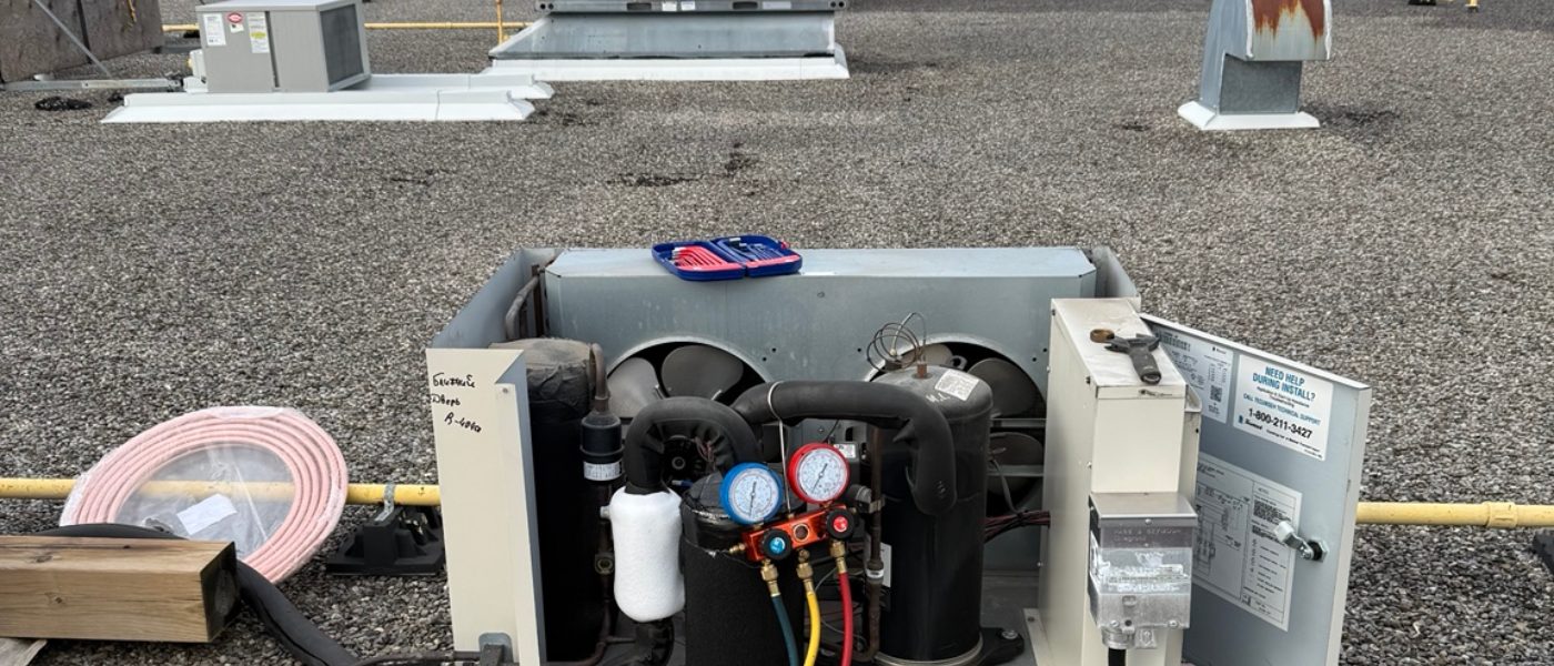 Rooftop commercial refrigeration condensing unit connected to service gauges