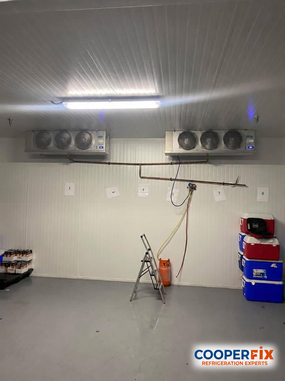 Two ceiling-mounted evaporators with pipework and a manifold gauge set