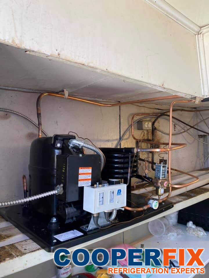 Open condensing section of commercial freezer equipment; general refrigeration service context