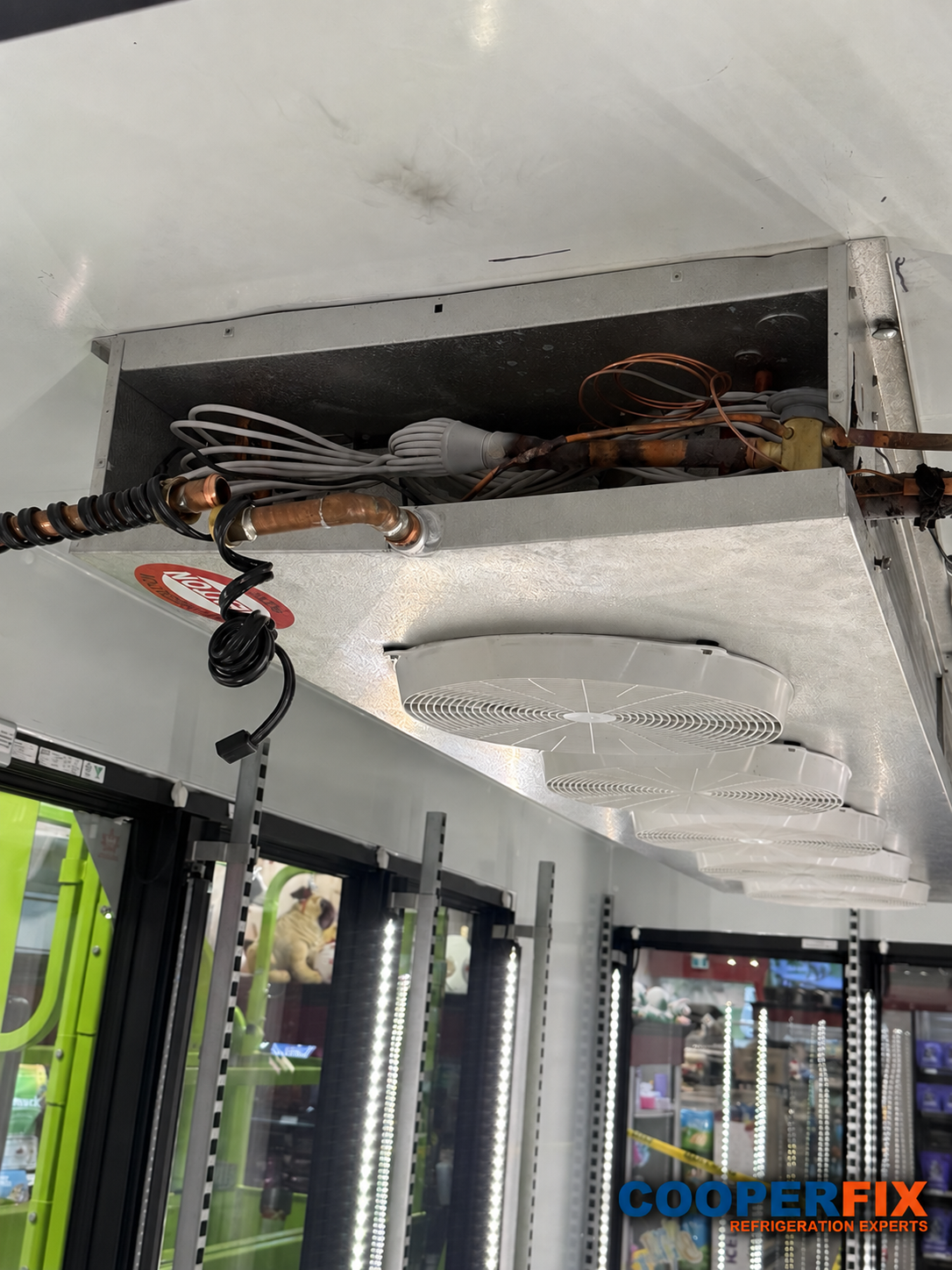 Evaporator line above refrigerated display cases