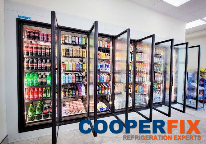 Multi-door commercial beverage refrigeration installation with glass doors open.