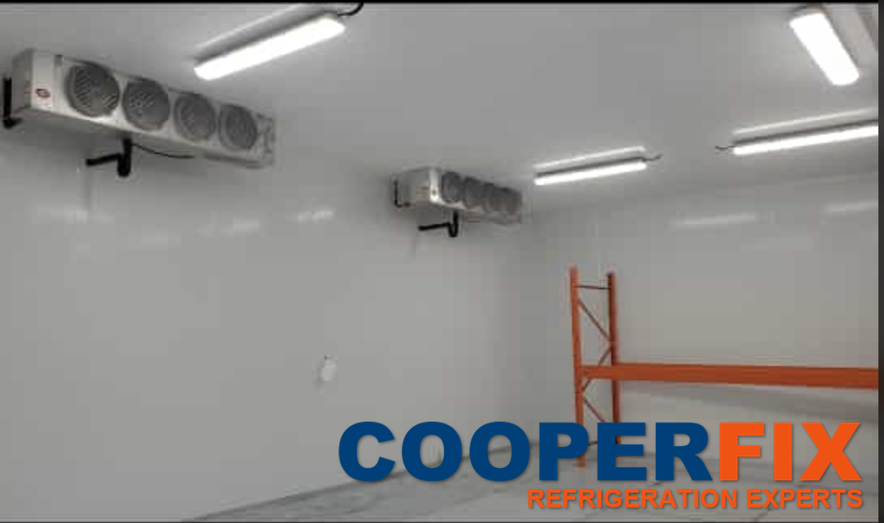 Two ceiling-mounted evaporator units inside a large cold room.