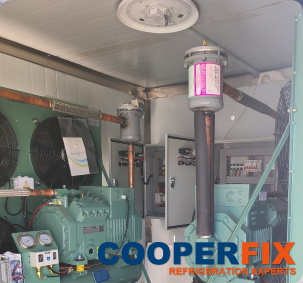 Industrial refrigeration compressor assemblies with connected refrigerant piping.