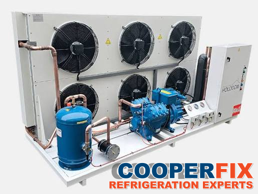 Refrigeration condensing assembly with compressors, fans and connected piping.