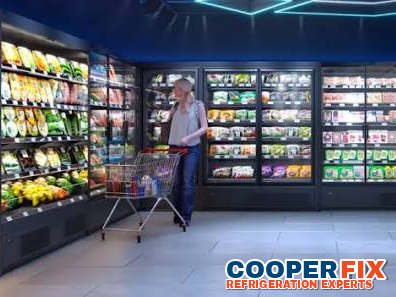 Commercial refrigerated display wall in a supermarket aisle.