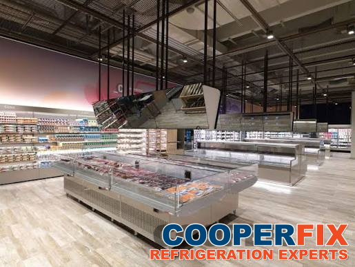 Low-profile island food display in a retail refrigeration installation.