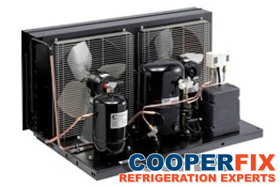 Refrigeration condensing unit with two fans, a compressor and connected piping.