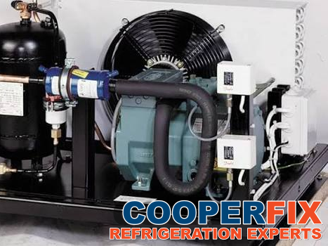 Commercial refrigeration condensing unit with compressor and receiver.