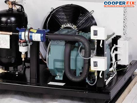 Commercial refrigeration condensing unit with compressor and receiver.